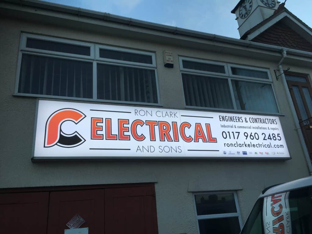 Commercial electrical sign for Ron Clark Electrical on building facade.