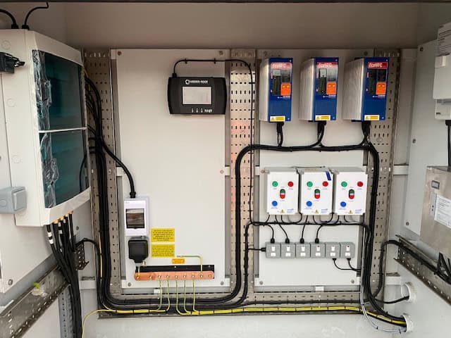 Commercial electrical control panel with circuit breakers and wiring.