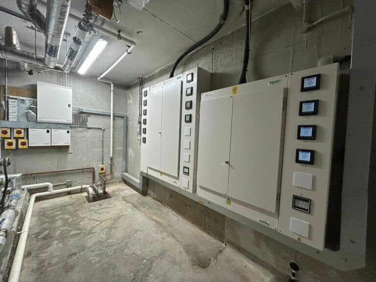 Electrical control panels and wiring in a commercial electrical room.