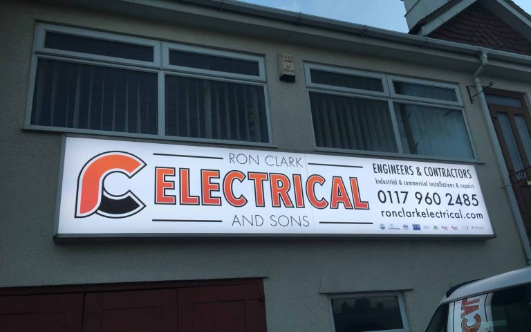 Commercial electrical sign for Ron Clark Electrical on building facade.
