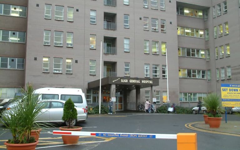 Sligo General Hospital building in Ireland with parking area.